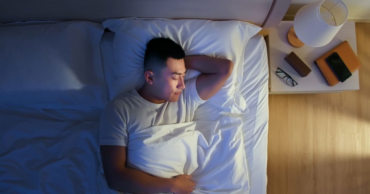 Male sleeping in bed